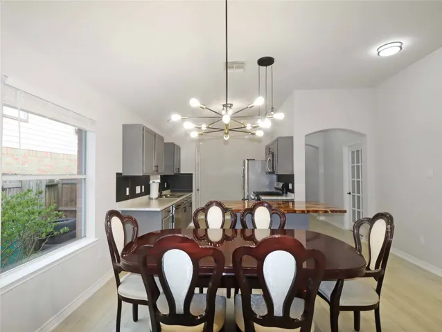 a view of a dining room with furniture and chandelier