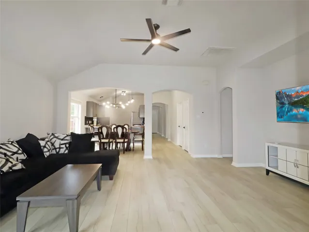 a living room with furniture and wooden floor