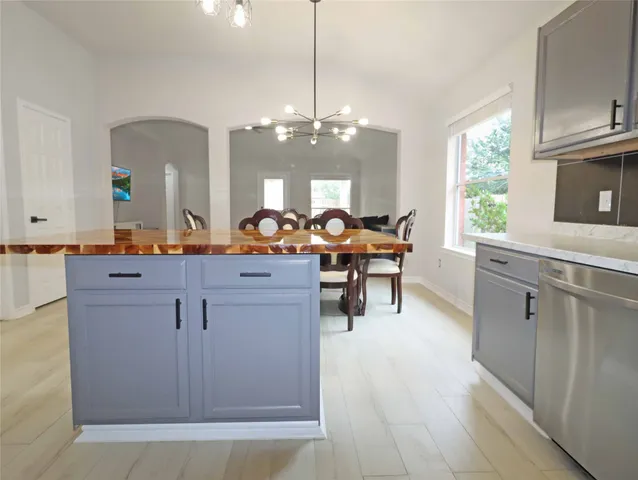 a view of living room with granite countertop furniture a fireplace and a window