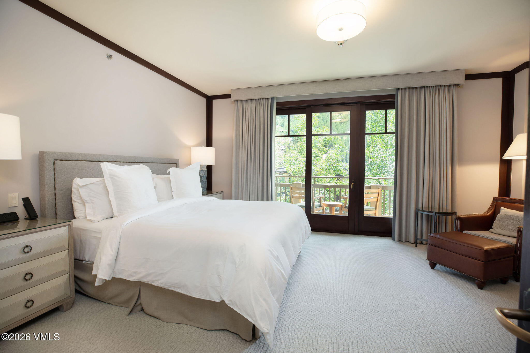 1 Vail Road, Unit 5102J Vail, CO 81657 - Photo 9 of 26 a bedroom with a bed and a couch next to a window