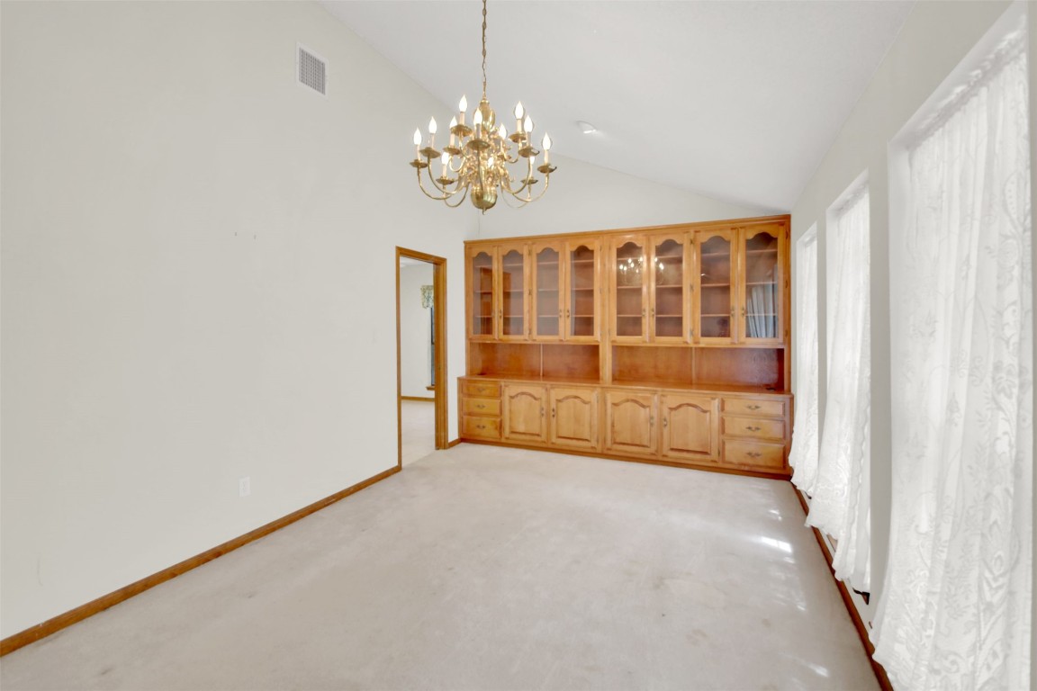 1403 Stone Ridge Drive Taylor, TX 76574 - Photo 12 of 39 Unfurnished dining area with high vaulted ceiling, a chandelier, and light colored carpet