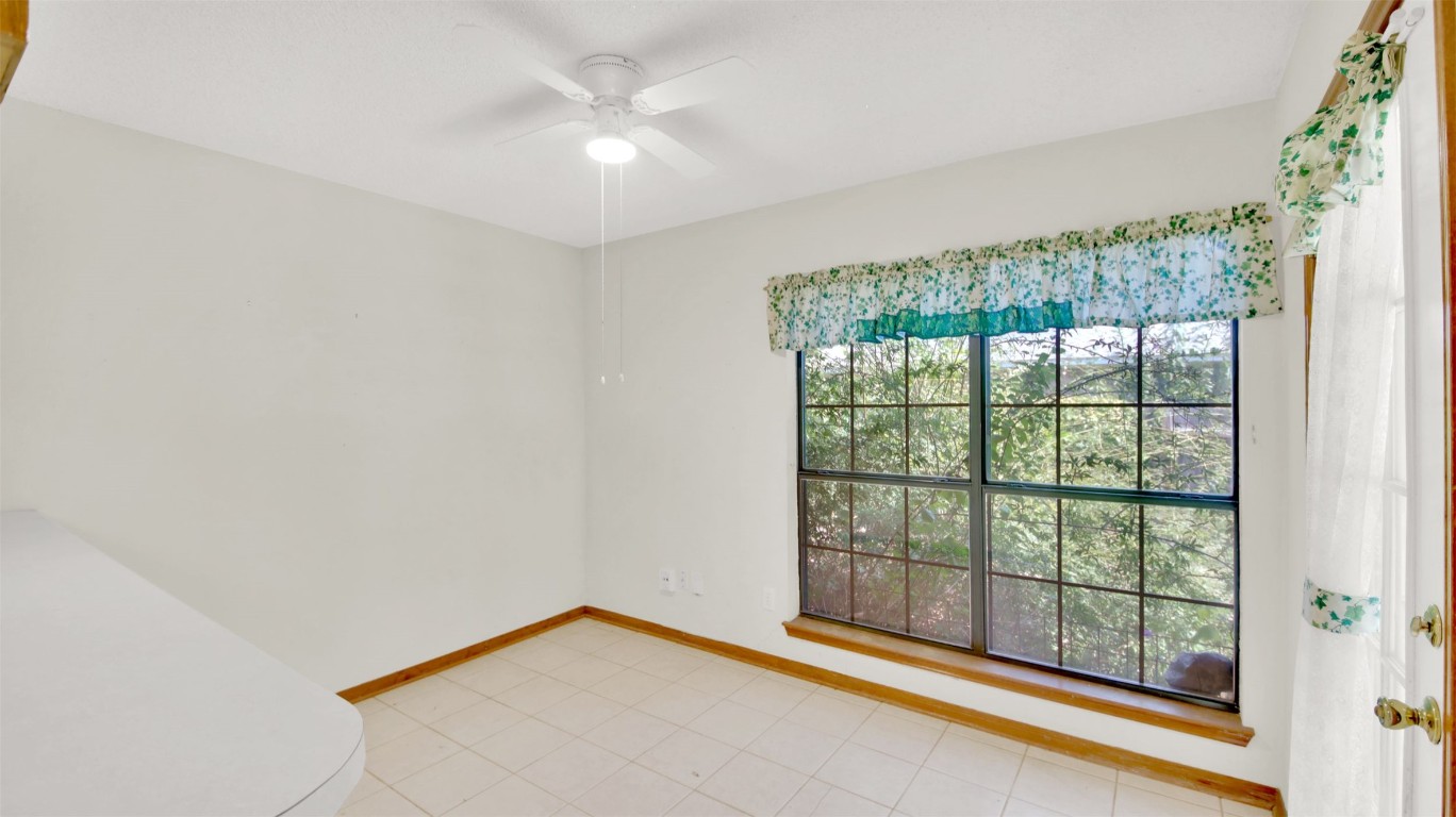 1403 Stone Ridge Drive Taylor, TX 76574 - Photo 20 of 39 Empty room featuring baseboards and a ceiling fan