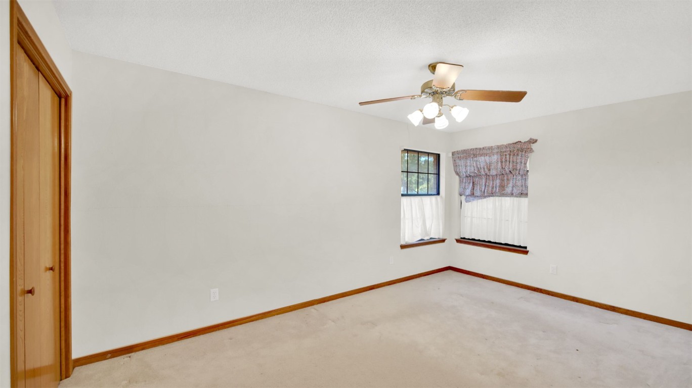 1403 Stone Ridge Drive Taylor, TX 76574 - Photo 24 of 39 Carpeted spare room with baseboards and ceiling fan