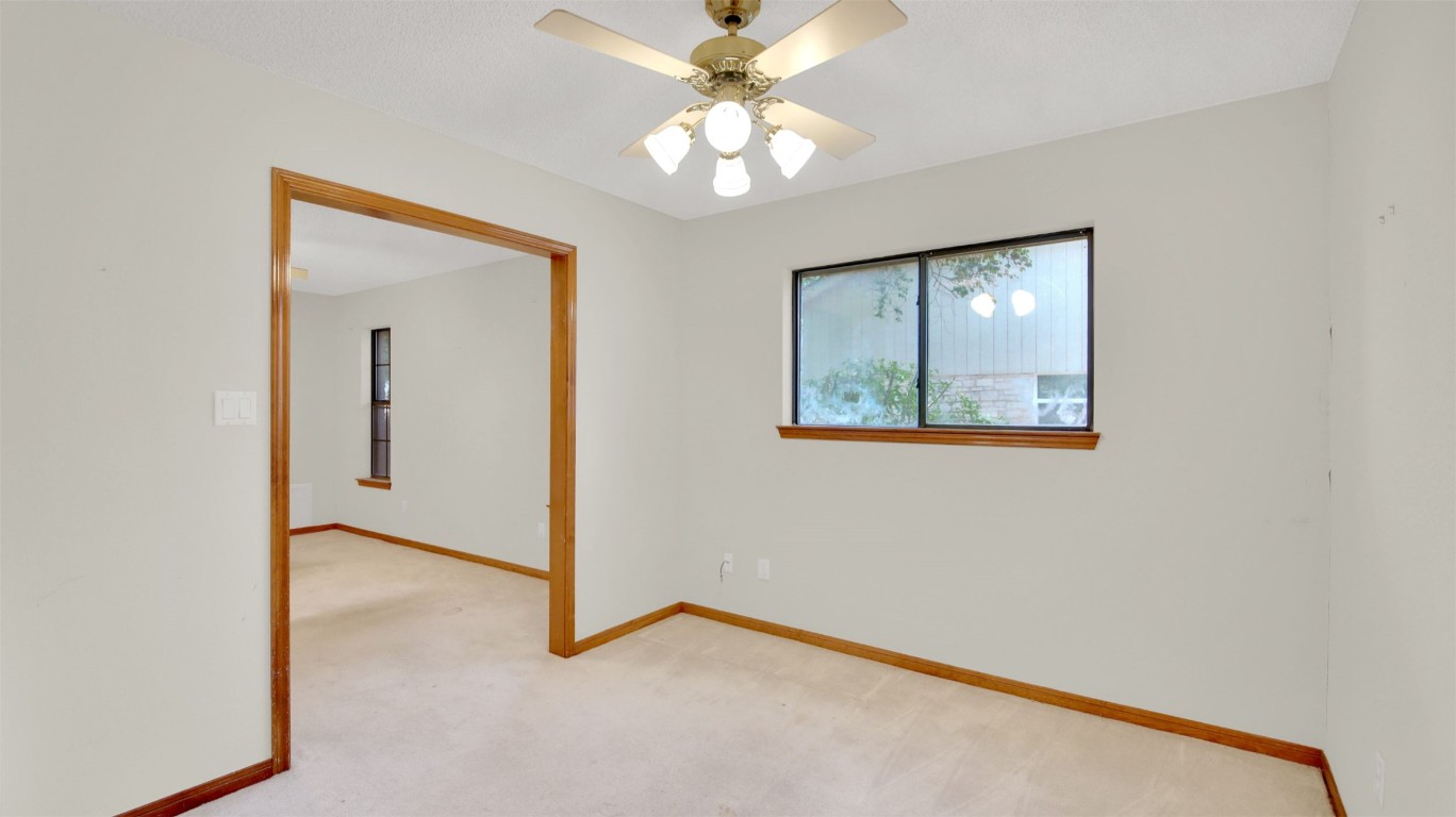 1403 Stone Ridge Drive Taylor, TX 76574 - Photo 26 of 39 Carpeted spare room with baseboards and ceiling fan