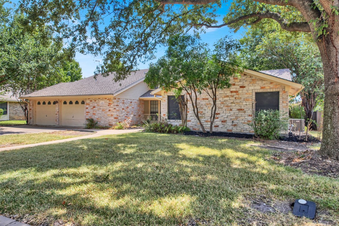 1403 Stone Ridge Drive Taylor, TX 76574 - Photo 3 of 39 Single story home with a front yard, a garage, driveway, and a shingled roof