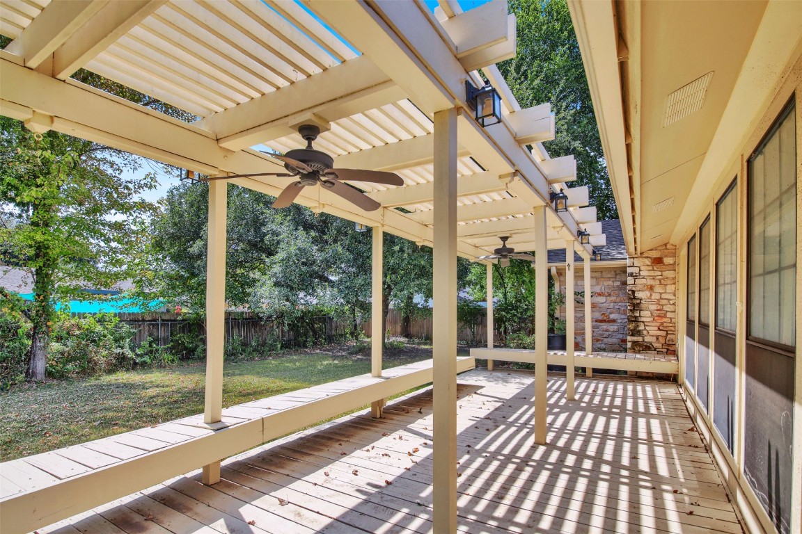 1403 Stone Ridge Drive Taylor, TX 76574 - Photo 34 of 39 Wooden terrace with a ceiling fan, a fenced backyard, and a pergola