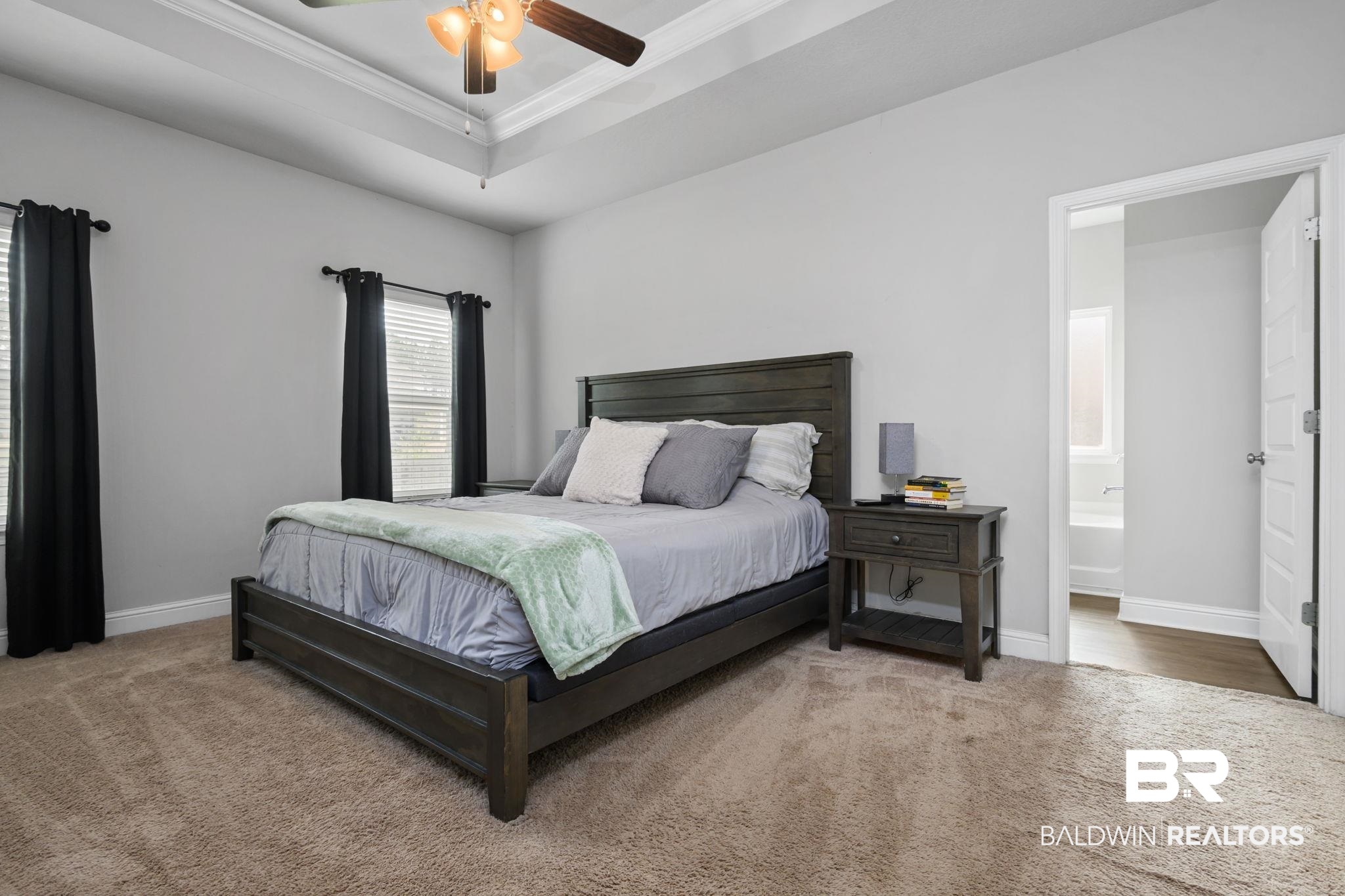 12693 Waxwing Avenue Daphne, AL 36527 - Photo 34 of 43 Bedroom with carpet, crown molding, a tray ceiling, a ceiling fan, and connected bathroom
