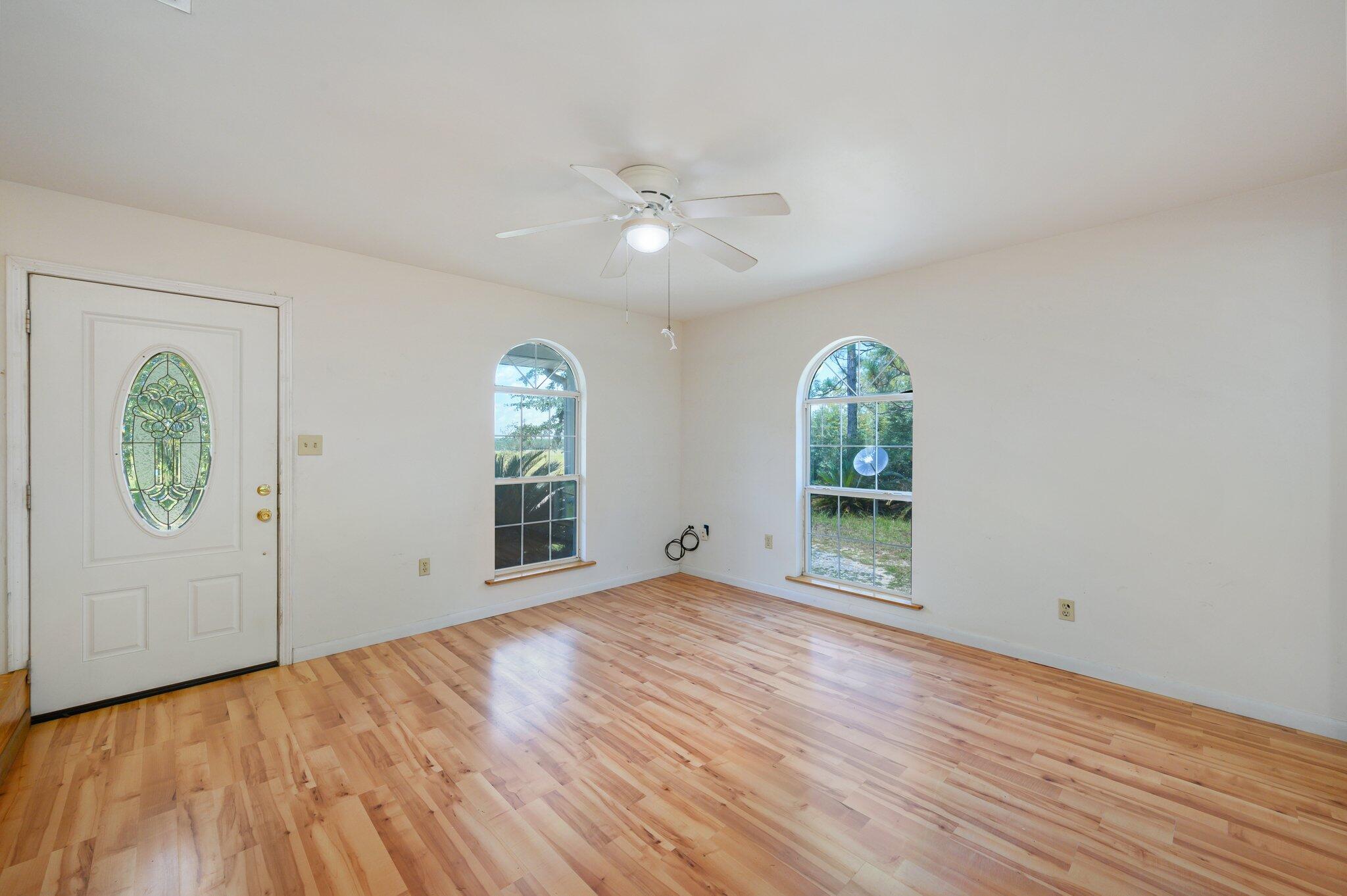 1361 Long Road DeFuniak Springs, FL 32433 - Photo 13 of 43 wooden floor in an empty room with a window