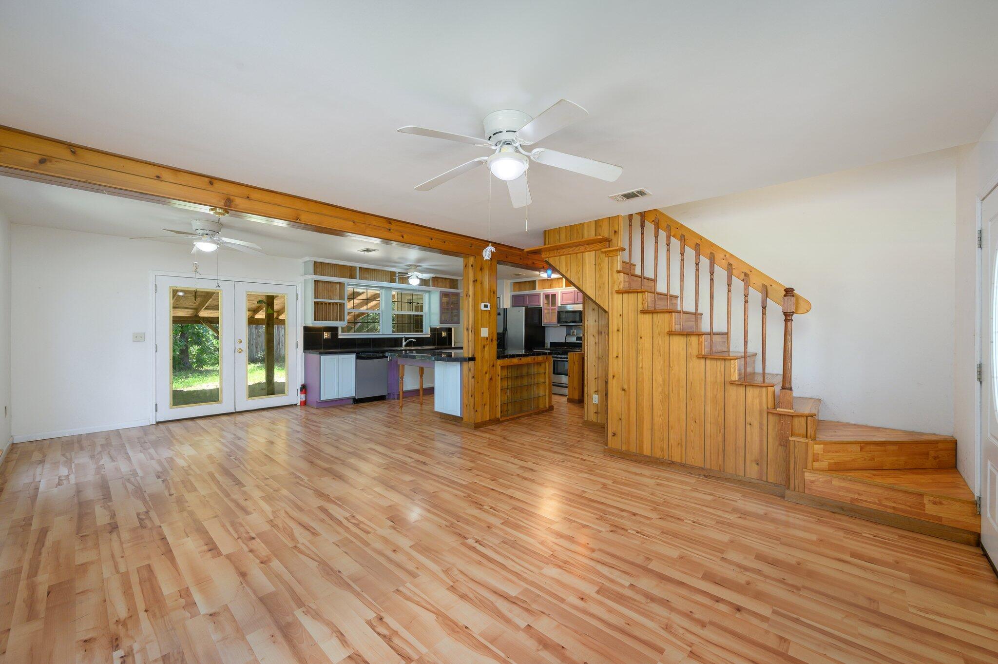 1361 Long Road DeFuniak Springs, FL 32433 - Photo 14 of 43 a view of a livingroom with wooden floor and a ceiling fan