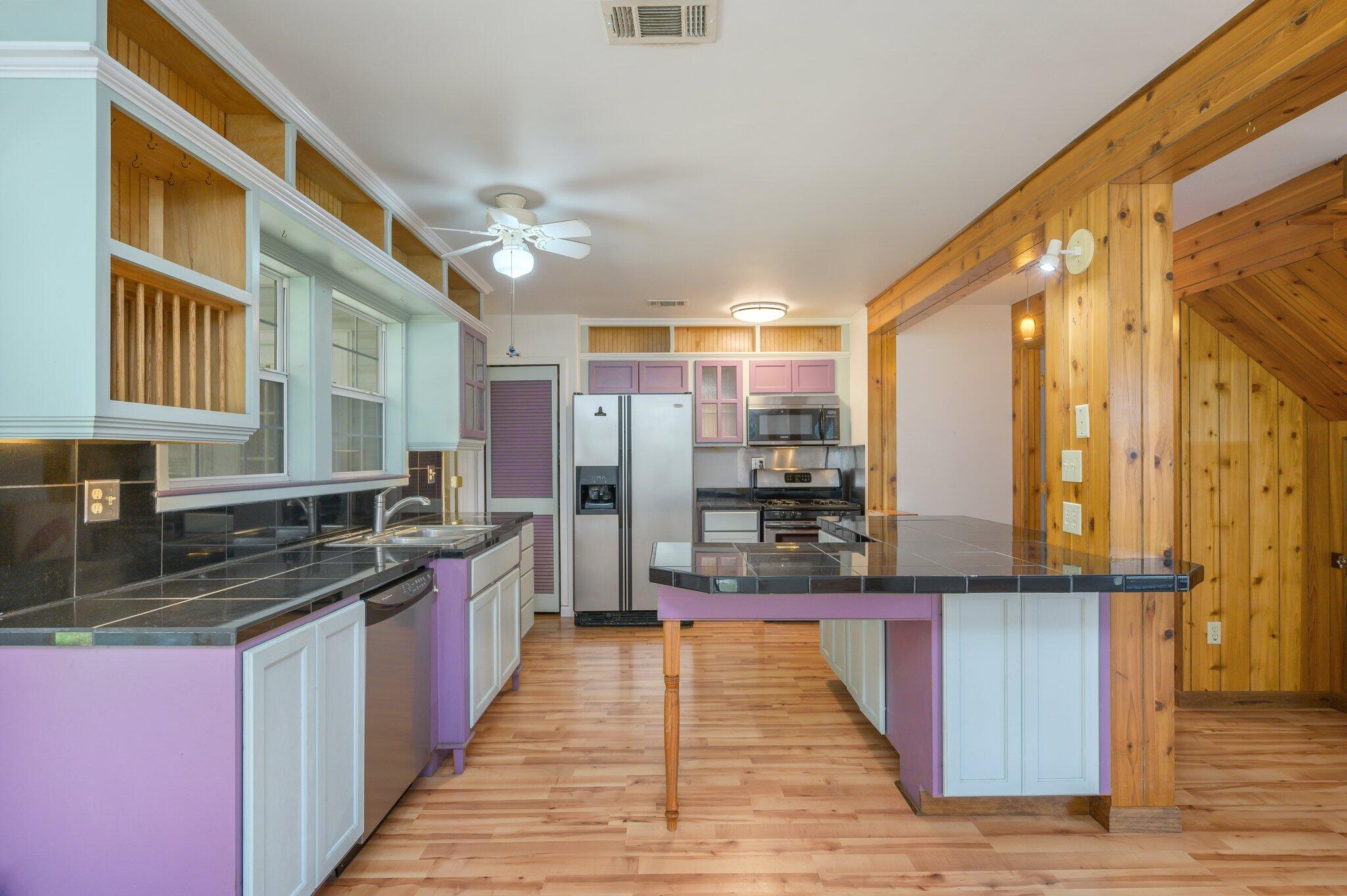 1361 Long Road DeFuniak Springs, FL 32433 - Photo 2 of 43 a large kitchen with stainless steel appliances granite countertop a stove and cabinets