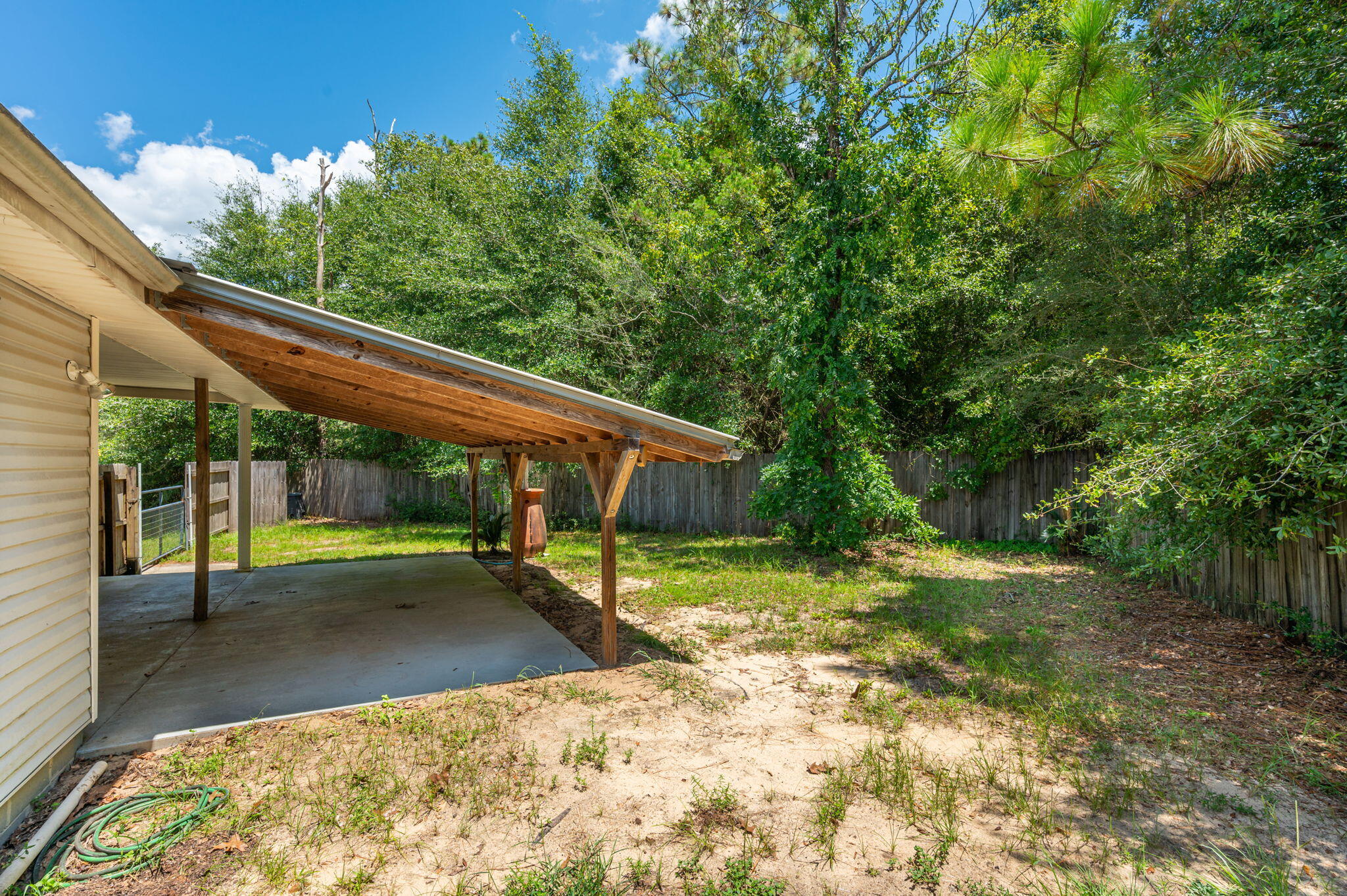 1361 Long Road DeFuniak Springs, FL 32433 - Photo 33 of 43 a backyard of a house with table and chairs