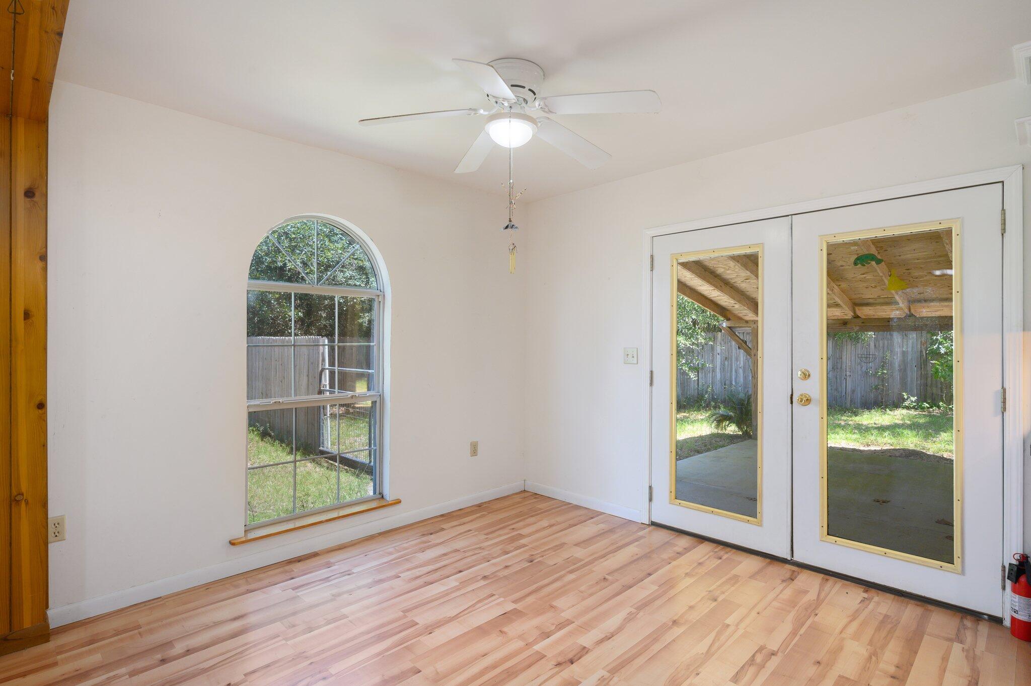 1361 Long Road DeFuniak Springs, FL 32433 - Photo 8 of 43 an empty room with wooden floor and windows