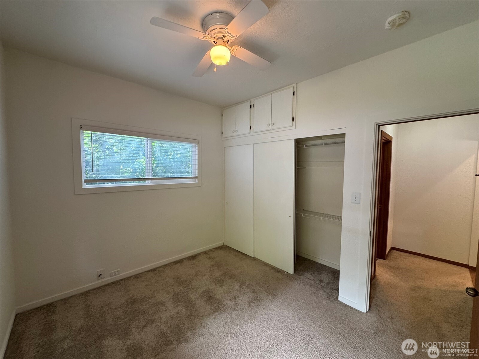 4521 49th Avenue Northeast Seattle, WA 98105 - Photo 11 of 20 an empty room with a window and a ceiling fan