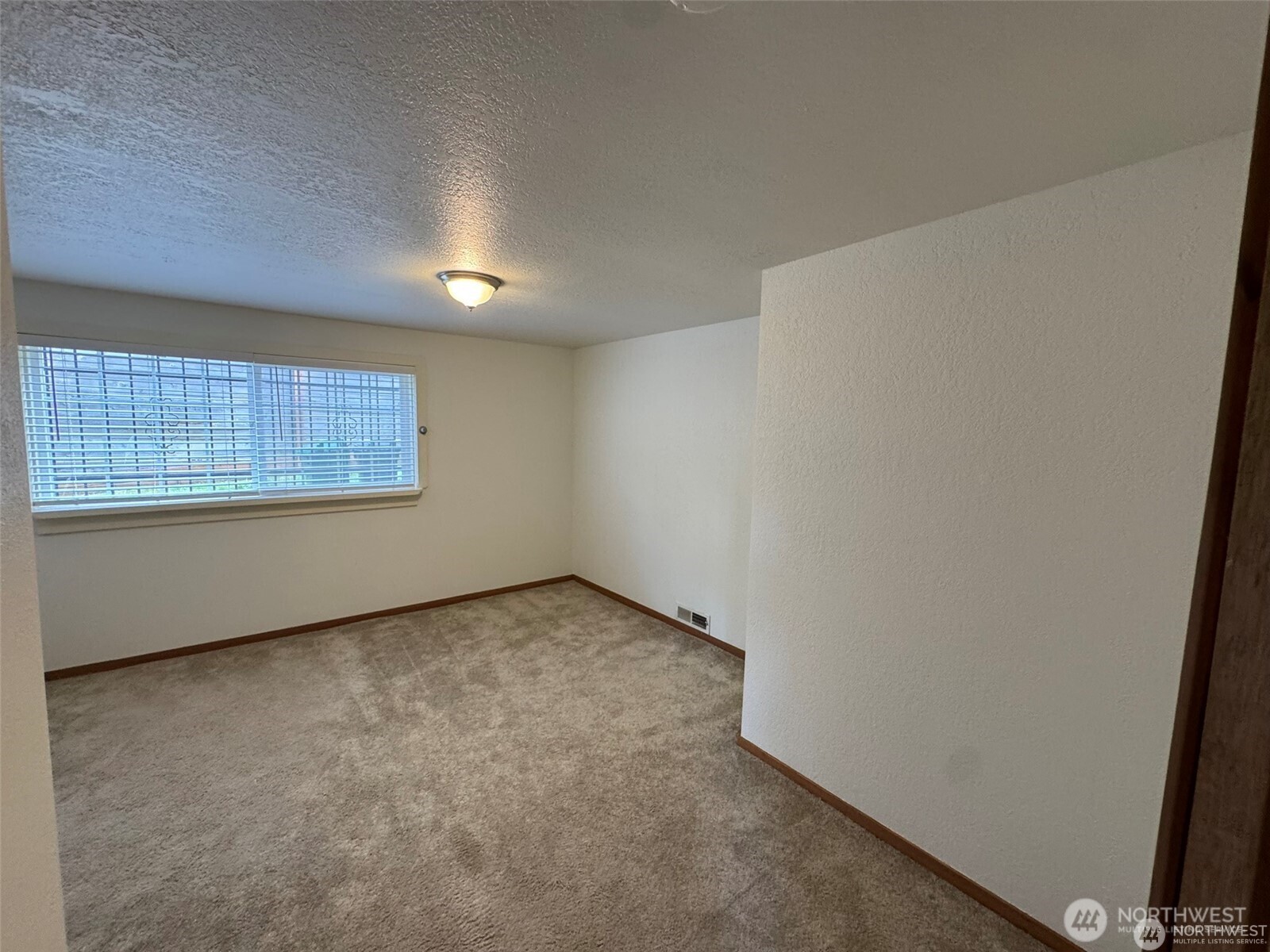 4521 49th Avenue Northeast Seattle, WA 98105 - Photo 15 of 20 an empty room with a window