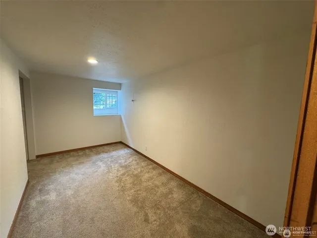 a view of an empty room and a window