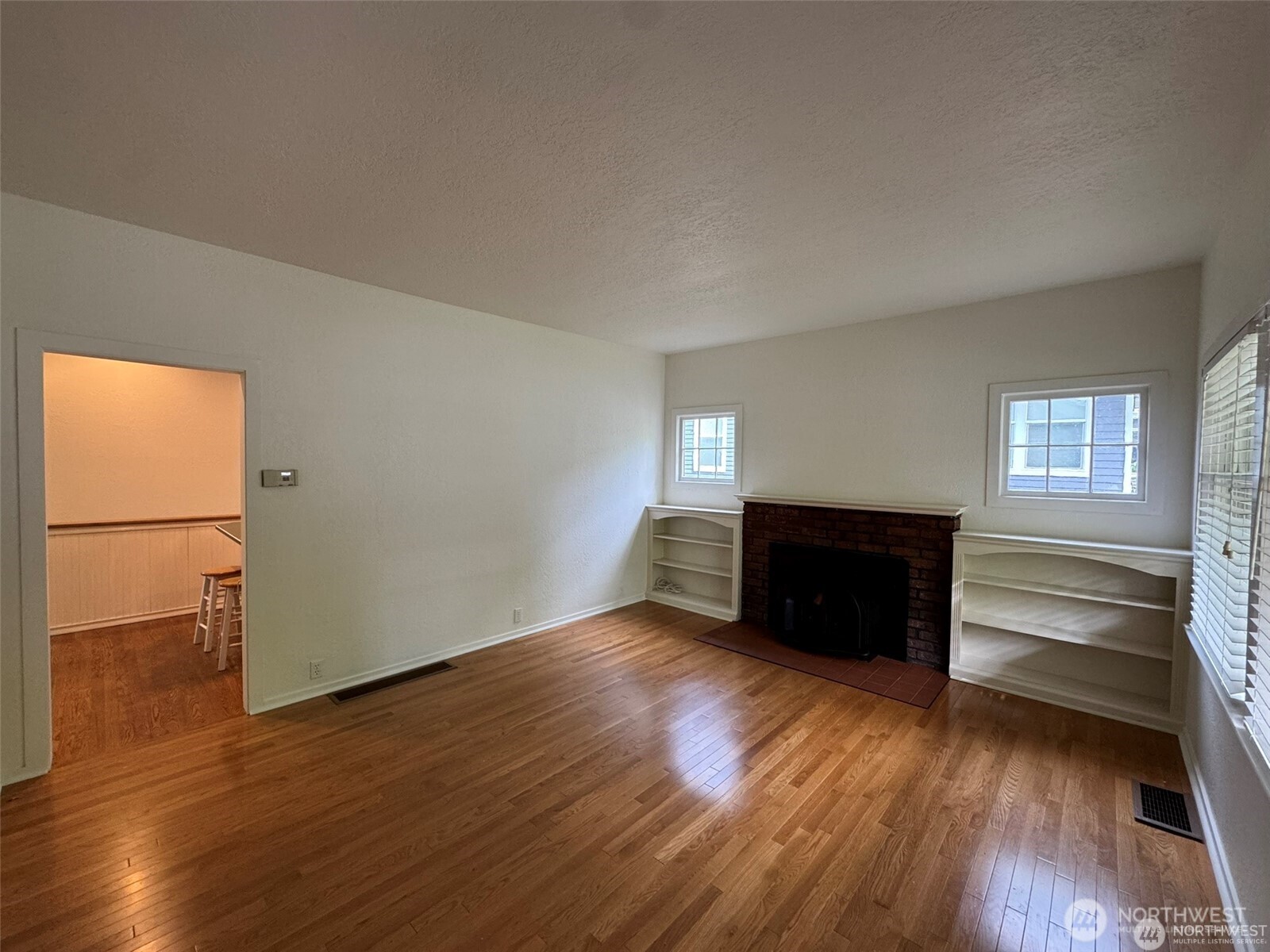 4521 49th Avenue Northeast Seattle, WA 98105 - Photo 3 of 20 wooden floor in an empty room with a window