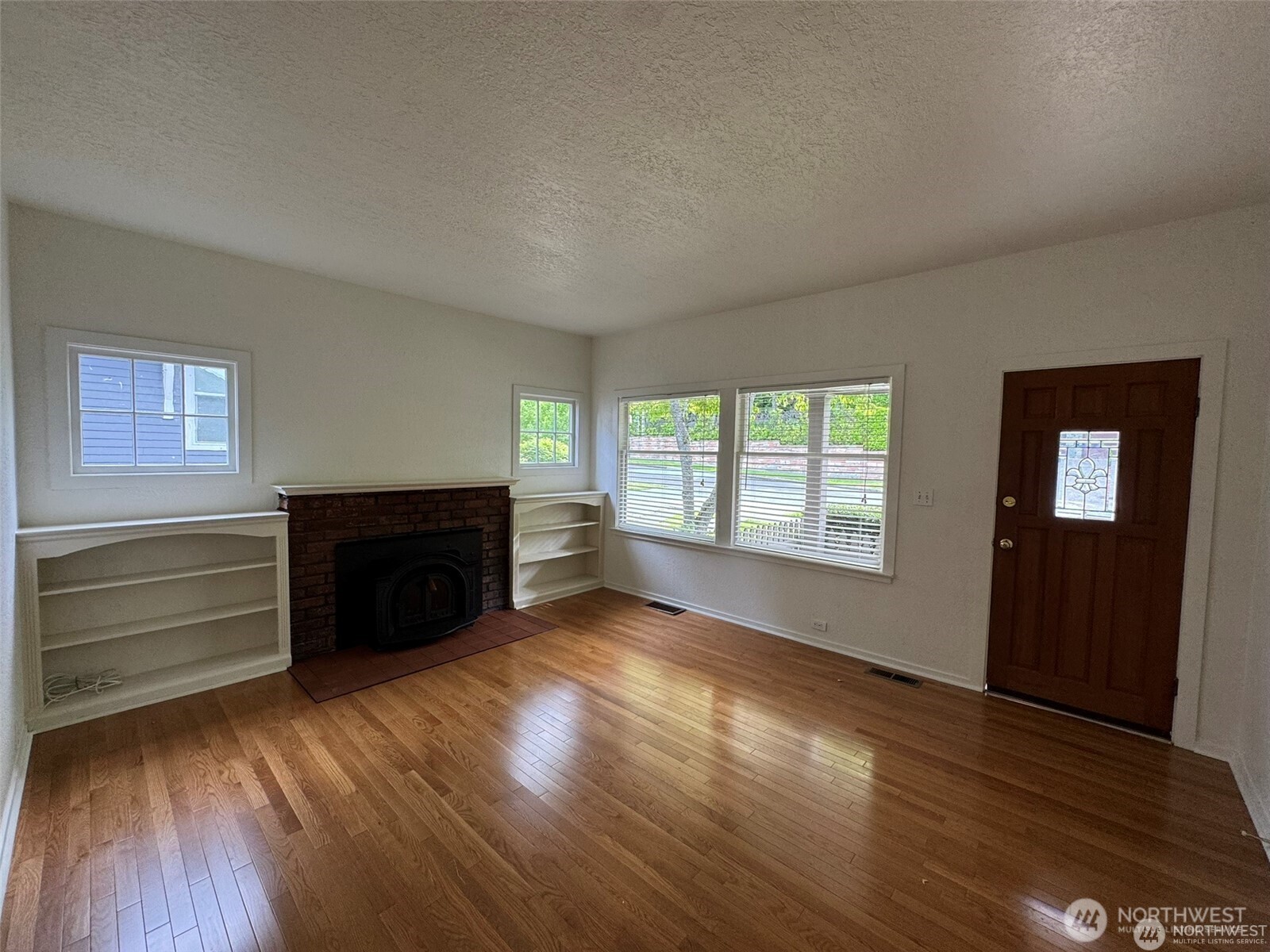 4521 49th Avenue Northeast Seattle, WA 98105 - Photo 4 of 20 a view of an empty room with a fireplace and a window