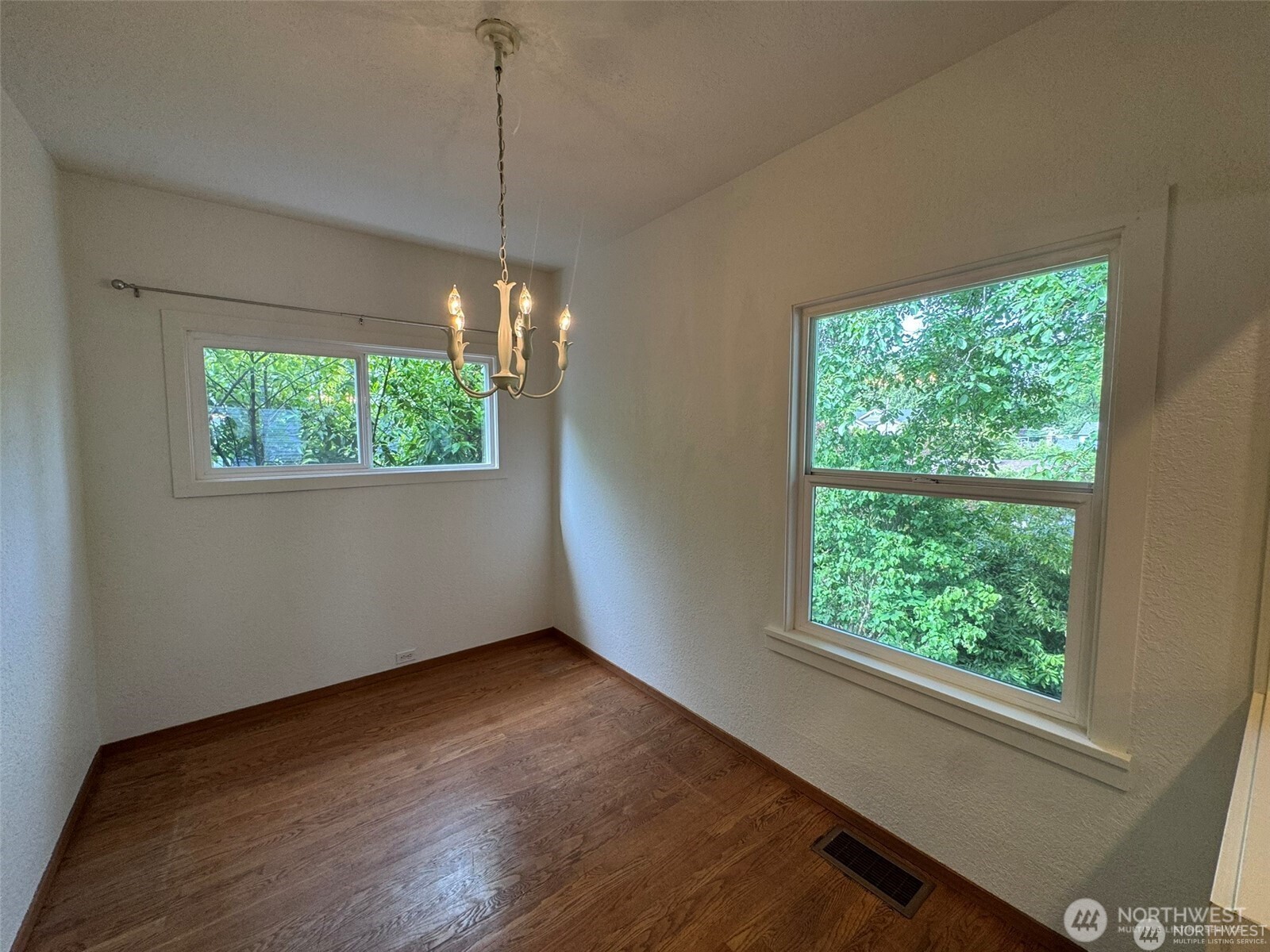 4521 49th Avenue Northeast Seattle, WA 98105 - Photo 8 of 20 a view of a room with wooden floor and a window