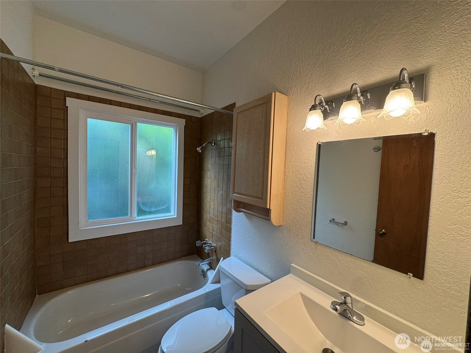 4521 49th Avenue Northeast Seattle, WA 98105 - Photo 9 of 20 a bathroom with a tub shower and sink