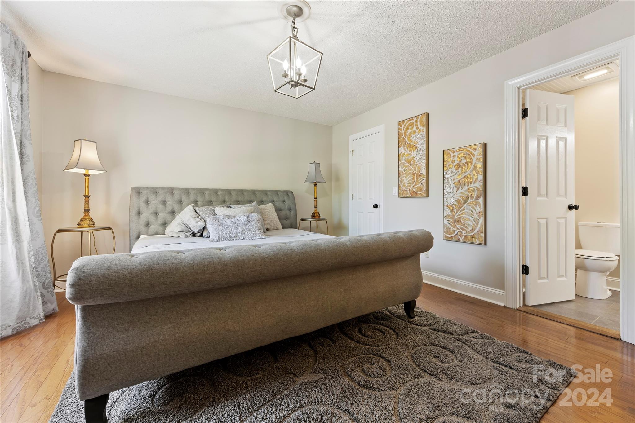 1313 Crown Ridge Drive Fort Mill, SC 29708 - Photo 15 of 35 a bedroom with a bed and a chandelier
