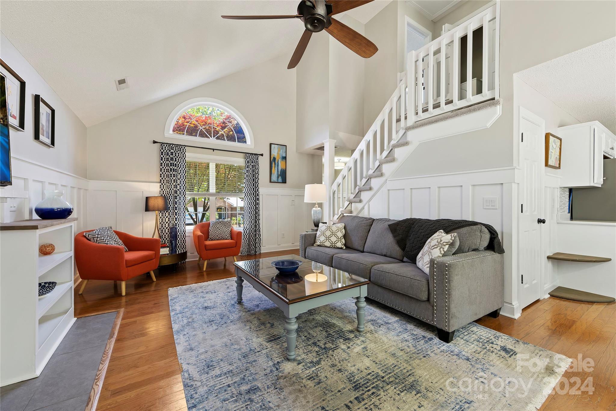 1313 Crown Ridge Drive Fort Mill, SC 29708 - Photo 7 of 35 a living room with furniture a rug and a chandelier