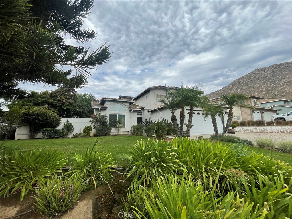 22740 Main Street Grand Terrace, CA 92313 - Photo 1 of 30 a view of a house with a big yard and potted plants