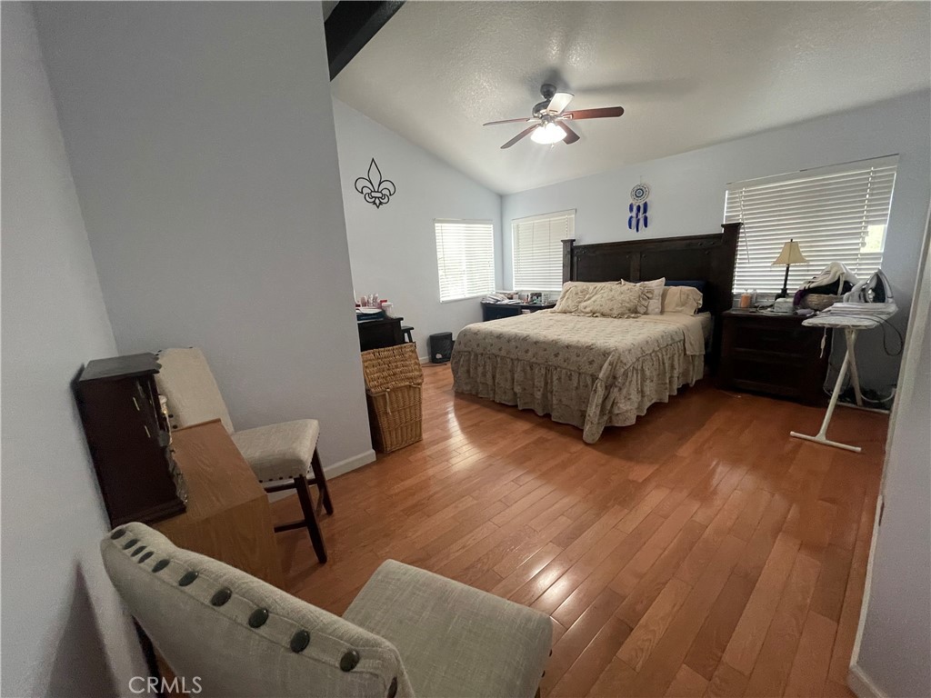 22740 Main Street Grand Terrace, CA 92313 - Photo 16 of 30 a spacious bedroom with a bed and furniture