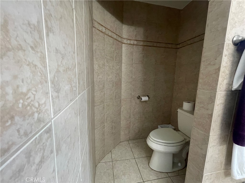 22740 Main Street Grand Terrace, CA 92313 - Photo 21 of 30 a bathroom with a toilet and a shower