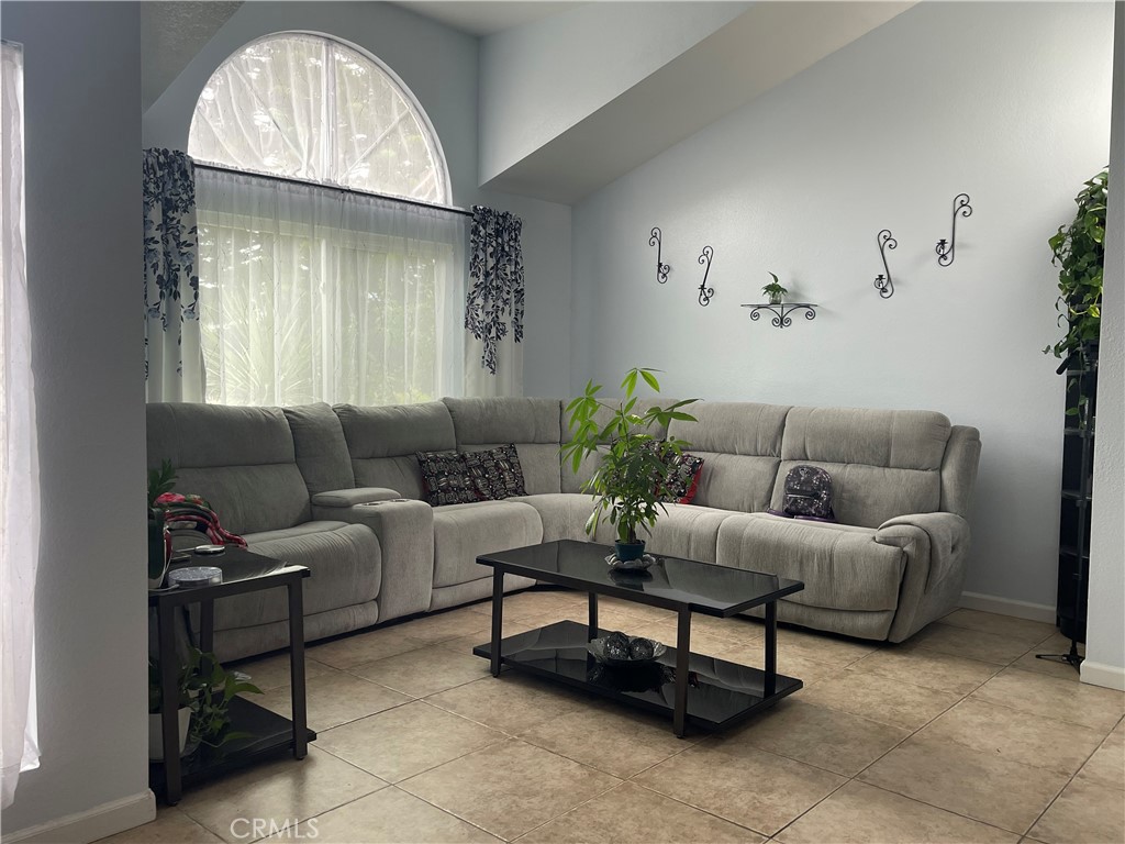 22740 Main Street Grand Terrace, CA 92313 - Photo 5 of 30 a living room with furniture and a large window