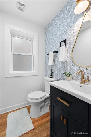 a bathroom with a sink toilet and mirror