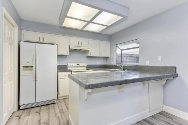 a kitchen with cabinets and appliances