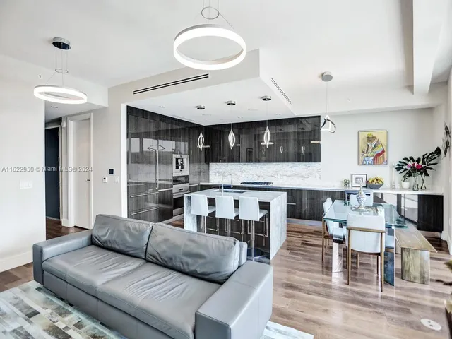 a view of a swimming pool with a yard and potted plants