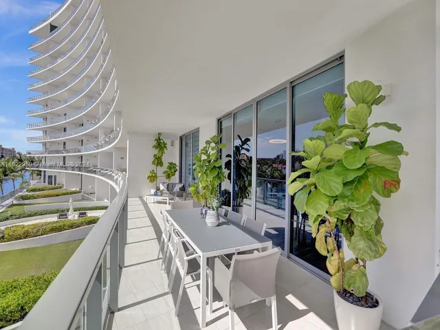 a bedroom with a large bed and a wooden floor