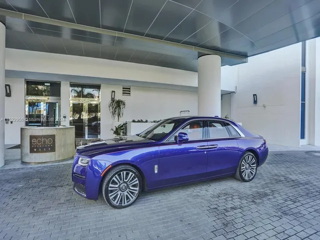 a living room with furniture and flowers