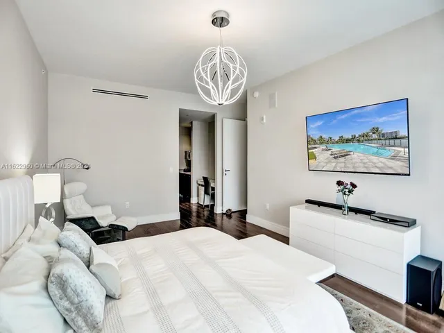 a bedroom with a bed and a television