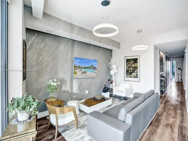 a living room with furniture and a potted plant