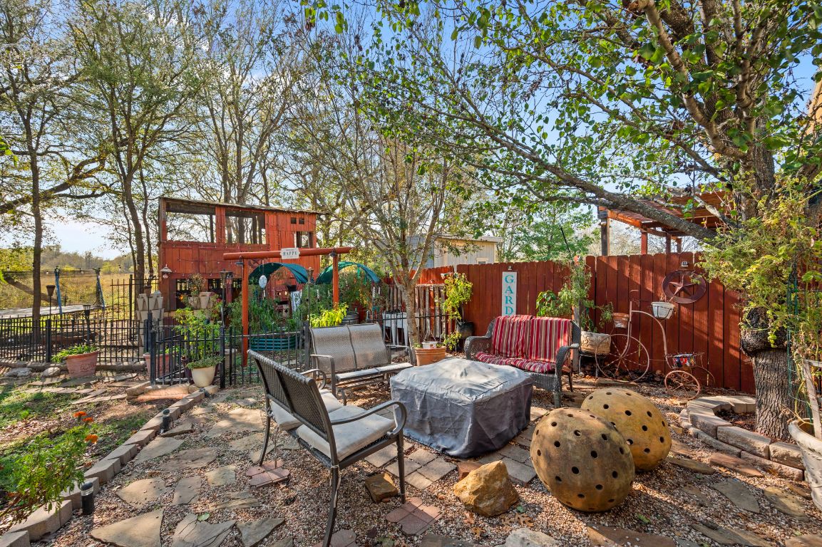 17813 Floribundas Lane Elgin, TX 78621 - Photo 33 of 39 a view of a chairs and table in backyard