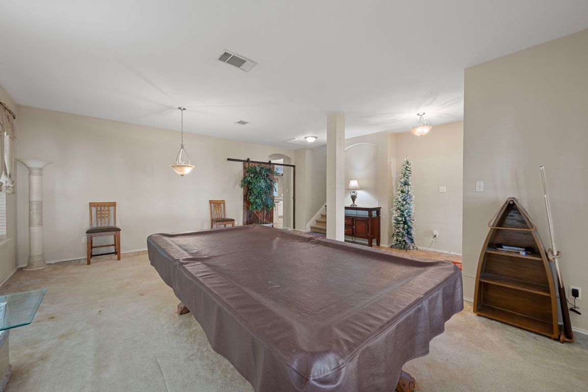 17813 Floribundas Lane Elgin, TX 78621 - Photo 5 of 39 a kitchen with stainless steel appliances granite countertop a stove a sink and a refrigerator