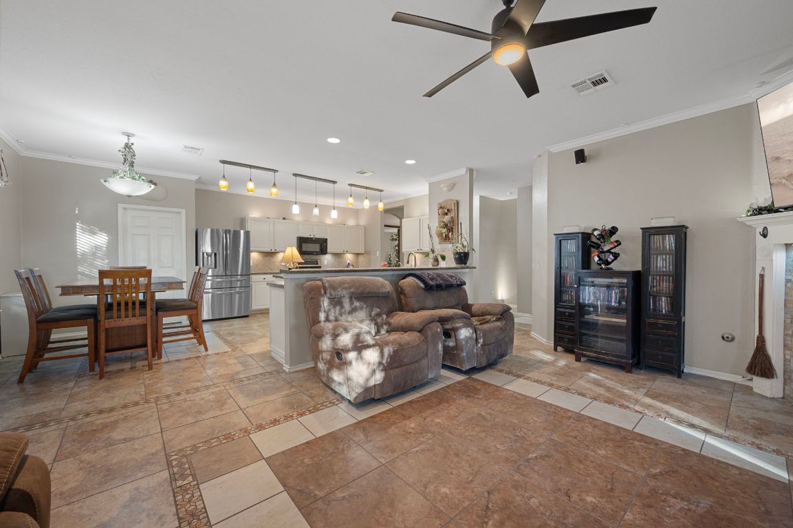 17813 Floribundas Lane Elgin, TX 78621 - Photo 8 of 39 a large living room with furniture a ceiling fan and a rug