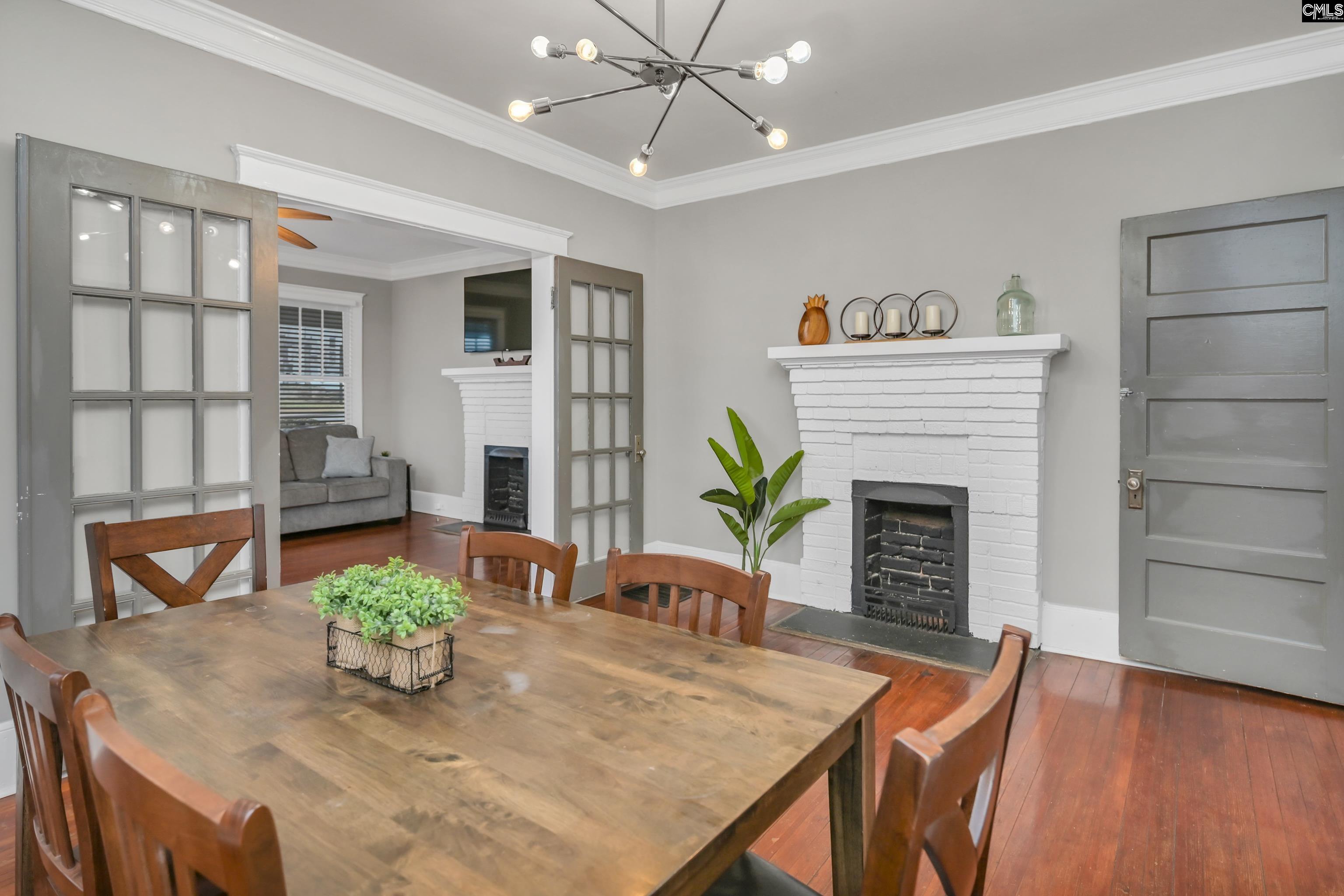 2227 Bull Street Columbia, SC 29201 - Photo 10 of 38 a view of a dining room with furniture and a fireplace