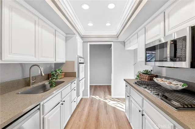 a kitchen with stainless steel appliances granite countertop a sink stove and cabinets