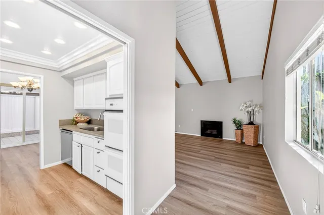 a view of a kitchen with cabinets appliances and wooden floor