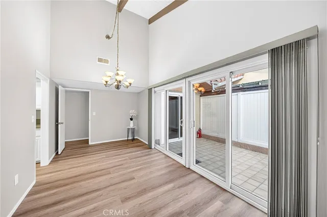 a view of an empty room with cabinet and a floor to ceiling window