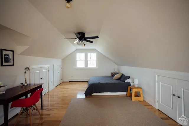 a bedroom with furniture and a window