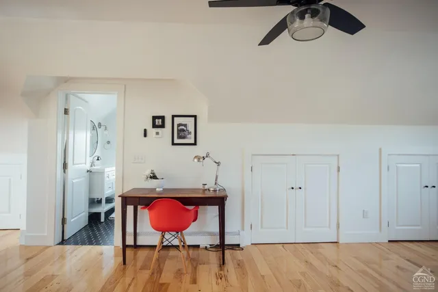 a view of a room with wooden floor and cabinet