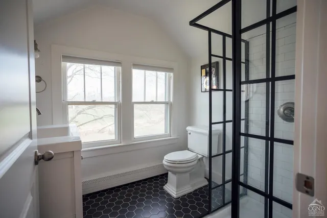 a bathroom with a toilet window and tub