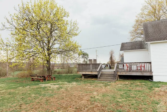 a view of a lake with a bench and trees