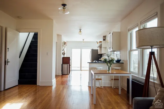 a kitchen with furniture and wooden floor