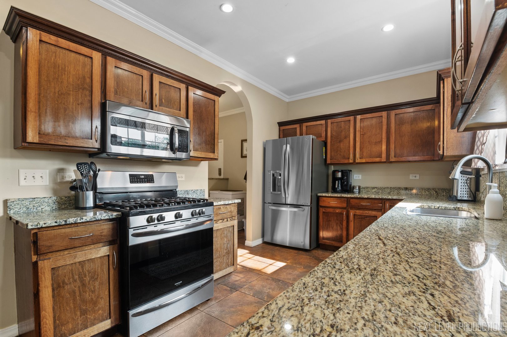 1683 Kautz Road Aurora, IL 60504 - Photo 3 of 26 a kitchen with stainless steel appliances granite countertop a stove sink microwave and refrigerator