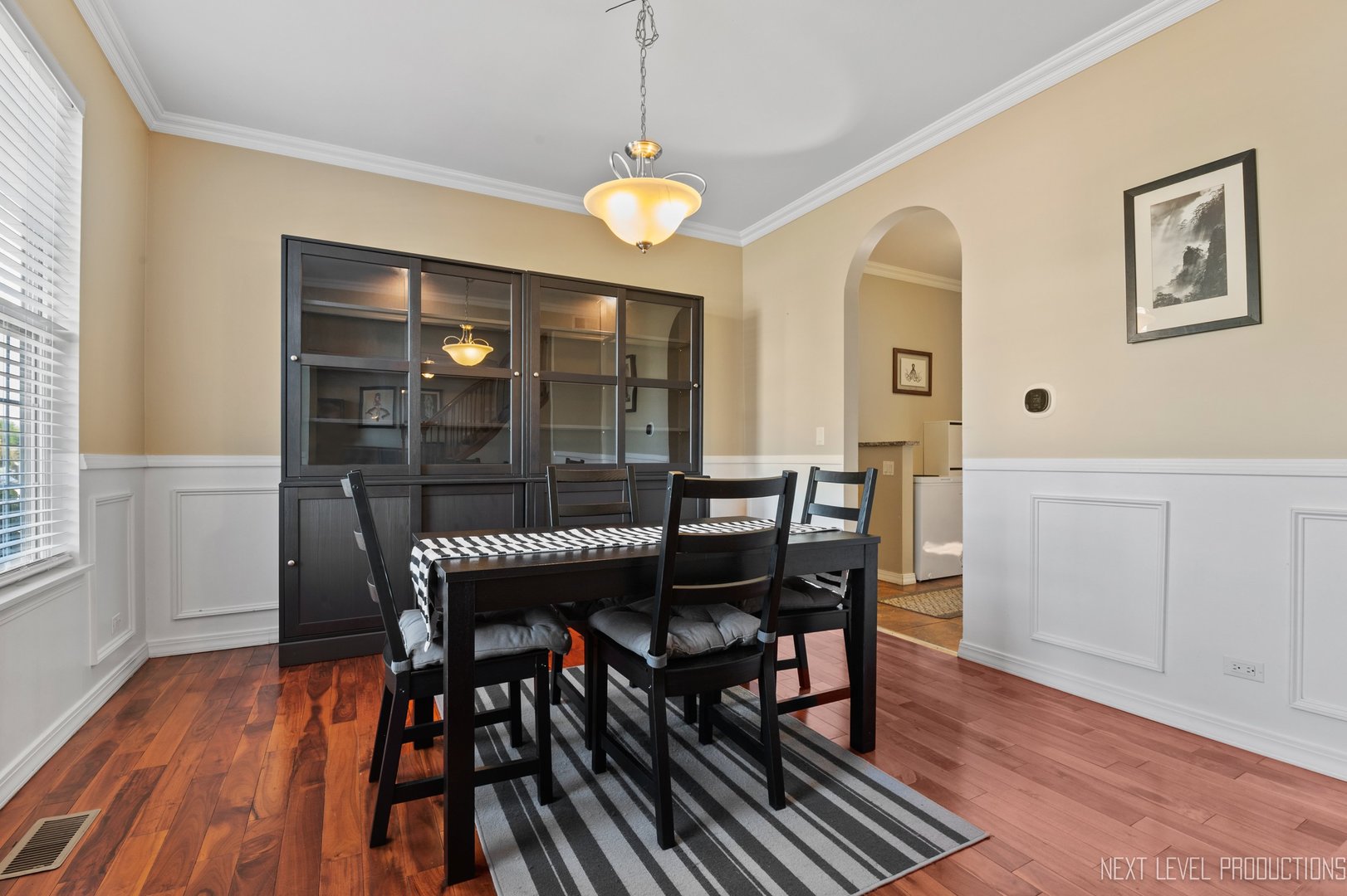 1683 Kautz Road Aurora, IL 60504 - Photo 8 of 26 a dining room with wooden floor a chandelier a wooden table and chairs